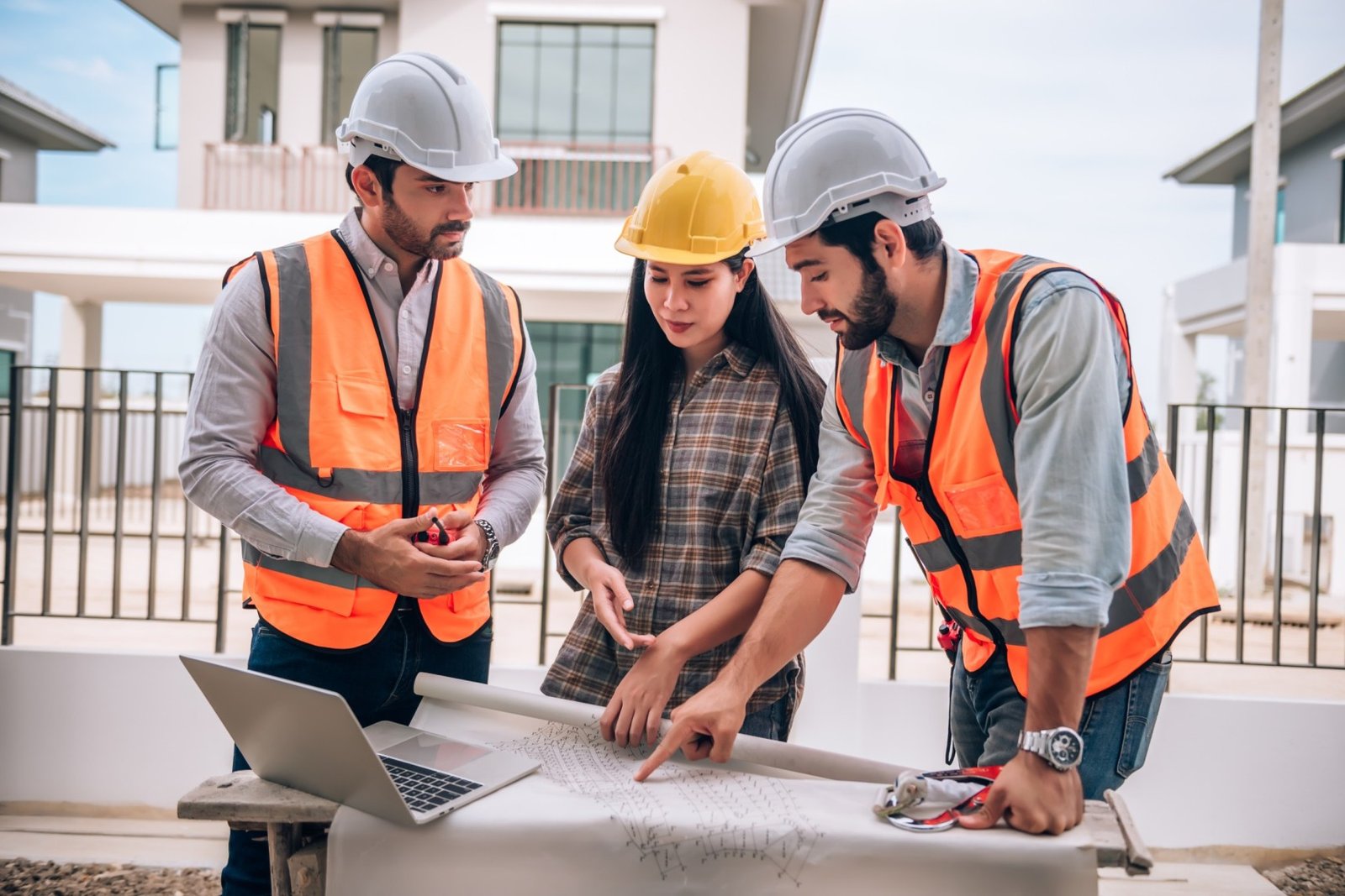 civil engineer construction worker architects wearing hardhats safety vests are working together construction site building home cooperation teamwork concept 1 1 1
